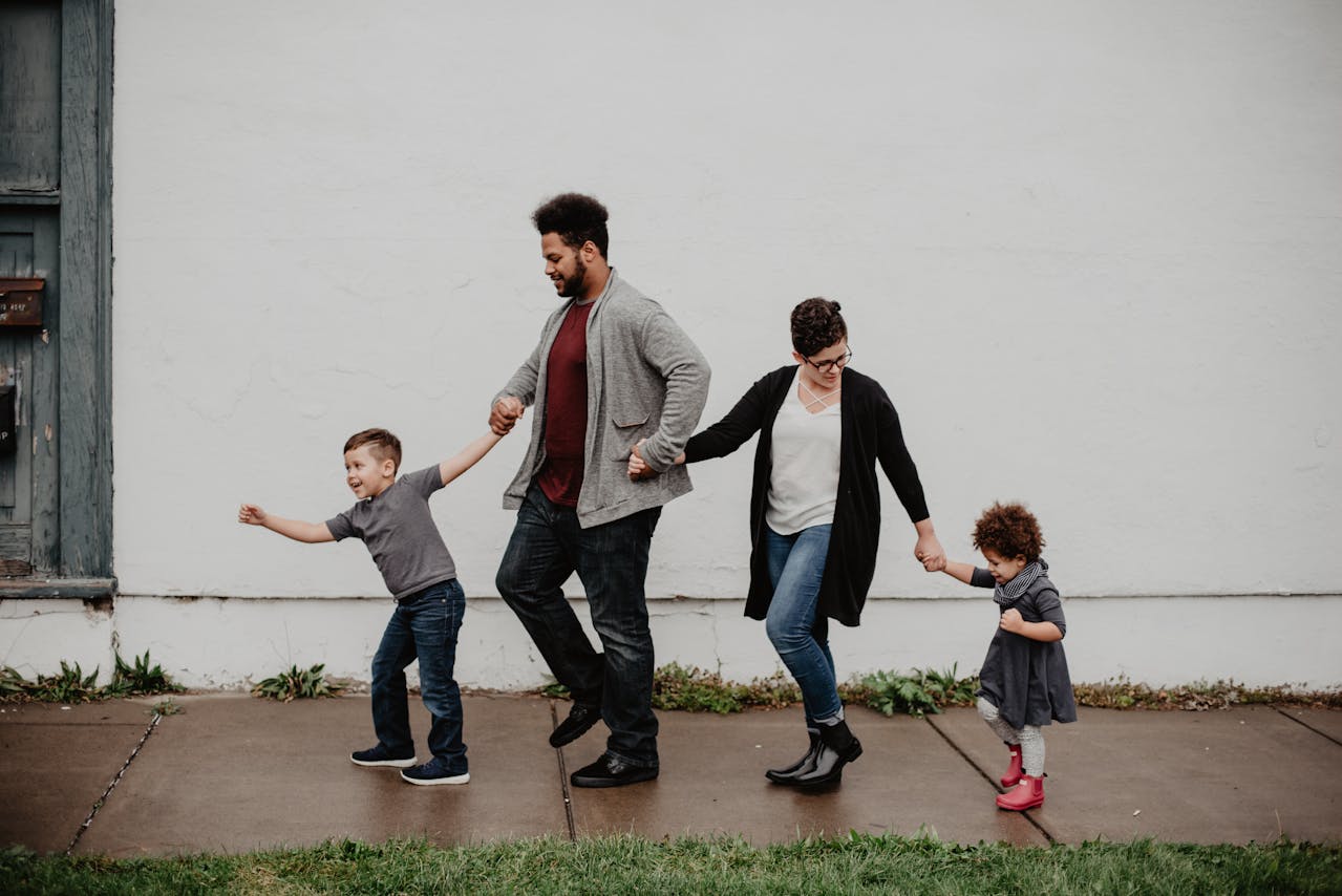 Married couple with two young kids walking together, highlighting family estate planning at Turke & Steil LLP in Madison, WI